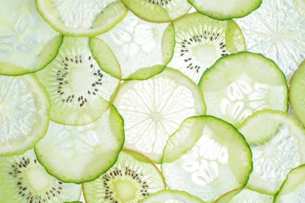 Close-up of fresh citrus and kiwi slices showcasing vibrant textures and colors.